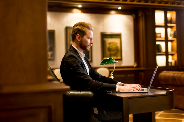 Security manager reviewing the Securinos mobile app in a luxury hotel lobby